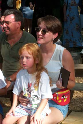 A Couple with a Cute Child Watching the Show